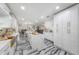 Open kitchen with an island, white cabinets, marble countertops, and views into the dining and living areas at 4814 Knights Loop, Plant City, FL 33565