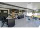 Bright outdoor kitchen with marble floor, black cabinets, island and dining area at 4814 Knights Loop, Plant City, FL 33565