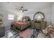 Comfortable primary bedroom suite featuring a decorative mirror, ceiling fan and large window at 4814 Knights Loop, Plant City, FL 33565