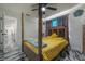 Bright main bedroom featuring a four-poster bed, modern ceiling fan, and access to a walk-in closet at 4814 Knights Loop, Plant City, FL 33565