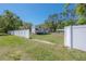 Wide-open yard with a white fence, mature trees, and an RV at 4814 Knights Loop, Plant City, FL 33565