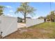 Backyard features a fence that adds security and a private parking pad at 5607 N Taliaferro Ave, Tampa, FL 33604