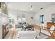 Bright living room with white brick fireplace, wood flooring, and neutral decor creates a cozy and stylish space at 5607 N Taliaferro Ave, Tampa, FL 33604