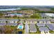 Aerial view of the community with a lake and clubhouse pool emphasizing the desirable neighborhood amenities at 5736 Grand Sonata Ave, Lutz, FL 33558