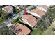 Aerial view of a home featuring a tile roof, lush landscaping, and a well-maintained lawn at 5839 Garden Lakes Dr, Bradenton, FL 34203