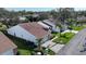 An aerial view of two homes featuring tile roofs, mature landscaping, well-manicured lawns, and brick driveways at 5839 Garden Lakes Dr, Bradenton, FL 34203