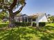 Beautiful backyard featuring a screened lanai and mature landscaping at 5839 Garden Lakes Dr, Bradenton, FL 34203