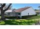 A back yard featuring an enclosed lanai with a tile roof and mature landscaping at 5839 Garden Lakes Dr, Bradenton, FL 34203
