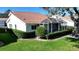 A back yard featuring an enclosed lanai with a tile roof and mature landscaping at 5839 Garden Lakes Dr, Bradenton, FL 34203