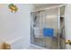 Bathroom showcasing a glass-enclosed shower with towel bars and a low-flow toilet at 5839 Garden Lakes Dr, Bradenton, FL 34203