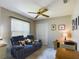 Cozy bedroom featuring a ceiling fan, a love seat, and a closet at 5839 Garden Lakes Dr, Bradenton, FL 34203
