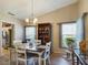 Bright dining area with wood floors, stylish lighting fixture, and views of the outdoors at 5839 Garden Lakes Dr, Bradenton, FL 34203