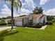 Well-manicured lawn with lush landscaping and a brick-accented garage, offering great curb appeal at 5839 Garden Lakes Dr, Bradenton, FL 34203