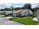 Charming single-story home featuring a well-manicured lawn, a tile roof, and an attached two-car garage at 5839 Garden Lakes Dr, Bradenton, FL 34203