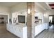 Bright open kitchen with white cabinets, granite countertops and brick pillar at 5839 Garden Lakes Dr, Bradenton, FL 34203