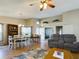 Open-concept living and dining area with neutral decor and wood flooring at 5839 Garden Lakes Dr, Bradenton, FL 34203