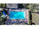 Aerial view of a sparkling community pool with lounge chairs and manicured landscaping around the perimeter at 5839 Garden Lakes Dr, Bradenton, FL 34203