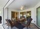 Covered porch featuring outdoor seating with views of the backyard and open living areas at 5839 Garden Lakes Dr, Bradenton, FL 34203