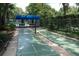Outdoor shuffleboard court surrounded by lush landscaping, offering a relaxing recreational area at 5839 Garden Lakes Dr, Bradenton, FL 34203