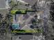 Overhead aerial showcasing the home's roofline, private pool, and mature landscaping in a neighborhood setting at 6107 Ibispark Dr, Lithia, FL 33547