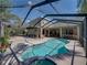 Beautiful aerial view of the screened-in pool and patio area, perfect for outdoor living and entertainment at 6107 Ibispark Dr, Lithia, FL 33547