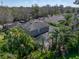 Aerial view of a backyard with a screened in pool surrounded by lush tropical landscaping at 6107 Ibispark Dr, Lithia, FL 33547