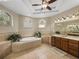 Bright and spacious bathroom with double sinks, tub, and large windows, providing a relaxing retreat at 6107 Ibispark Dr, Lithia, FL 33547