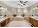 Elegant bathroom with double vanities, a corner tub, and natural light offers a spa-like atmosphere at 6107 Ibispark Dr, Lithia, FL 33547