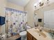 Cozy bathroom with seashell themed shower curtain, and neutral colored walls at 6107 Ibispark Dr, Lithia, FL 33547