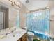 Full bathroom with a colorful world map shower curtain and a clean design at 6107 Ibispark Dr, Lithia, FL 33547