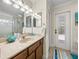 Bright bathroom featuring a single vanity sink and exterior access at 6107 Ibispark Dr, Lithia, FL 33547
