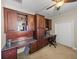 Spacious bedroom with custom built-in desk, shelving and ceiling fan at 6107 Ibispark Dr, Lithia, FL 33547