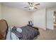 Relaxing bedroom features a ceiling fan, closet, and neutral paint colors at 6107 Ibispark Dr, Lithia, FL 33547