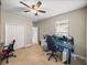 Carpeted bedroom featuring ceiling fan and large gaming computer setup at 6107 Ibispark Dr, Lithia, FL 33547