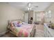 Bright bedroom featuring a white bed frame, arched windows, and soft textures at 6107 Ibispark Dr, Lithia, FL 33547
