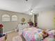Cozy bedroom with a rainbow bedspread and ample natural light at 6107 Ibispark Dr, Lithia, FL 33547