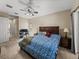 Comfortable bedroom with ceiling fan, neutral walls, and large window provides relaxation and natural light at 6107 Ibispark Dr, Lithia, FL 33547