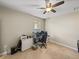 Carpeted bedroom featuring ceiling fan and large gaming computer setup at 6107 Ibispark Dr, Lithia, FL 33547