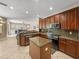 Open kitchen with stainless steel appliances, an island, dark cabinets, and a seamless connection to living area at 6107 Ibispark Dr, Lithia, FL 33547