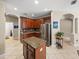 Gourmet kitchen showcases granite counters, stainless appliances, and a functional center island at 6107 Ibispark Dr, Lithia, FL 33547