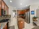 Spacious kitchen featuring dark wood cabinetry, granite countertops, and stainless steel appliances at 6107 Ibispark Dr, Lithia, FL 33547
