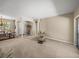 Spacious living area with neutral walls, carpet flooring, and seamless flow into the dining area at 6107 Ibispark Dr, Lithia, FL 33547