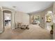 Spacious living room with neutral carpet, sliding glass doors to the pool, and arched doorways at 6107 Ibispark Dr, Lithia, FL 33547