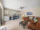Cozy living room with custom built-ins, plush seating, and a ceiling fan at 6107 Ibispark Dr, Lithia, FL 33547