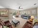 Inviting living room with access to the pool area, ceiling fan, and custom shelving at 6107 Ibispark Dr, Lithia, FL 33547