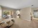 Open-concept living room with access to the lanai and pool, featuring neutral tones and ample space at 6107 Ibispark Dr, Lithia, FL 33547