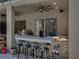 A beautiful covered outdoor bar with seating provides an excellent space for entertaining and relaxation at 6107 Ibispark Dr, Lithia, FL 33547
