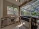 An outdoor kitchen made from stone next to the pool at 6107 Ibispark Dr, Lithia, FL 33547