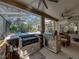 Amazing outdoor kitchen with built-in grill and island, perfect for entertaining guests with a screened-in pool in the background at 6107 Ibispark Dr, Lithia, FL 33547