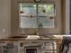 An outdoor kitchen featuring a sink, cooktop, and microwave at 6107 Ibispark Dr, Lithia, FL 33547